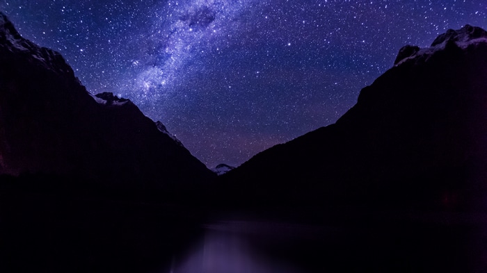 Milky Way over mountains and lake in New Zealand