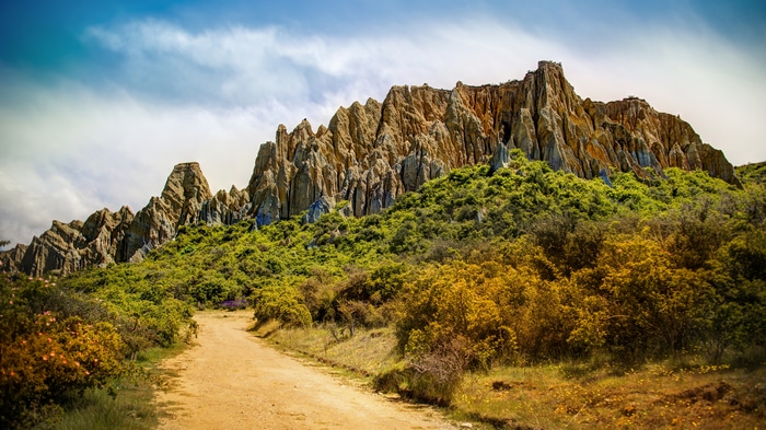 4K New Zealand Landscape with Rocky Peaks and Path