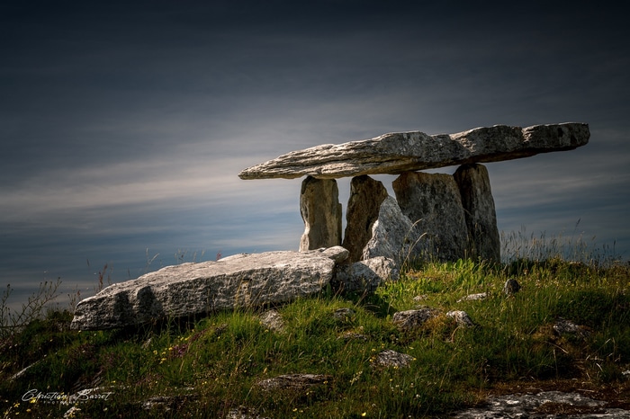 Poulnabrone Dolmen in Ireland under a cloudy sky