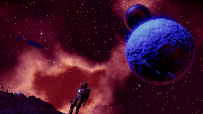 Astronaut on a planet in No Man's Sky with planets and stars