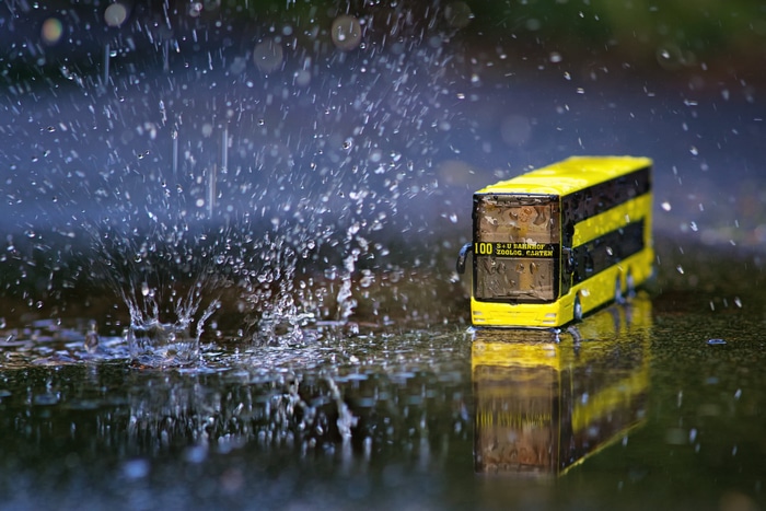 Yellow double-decker bus in the rain