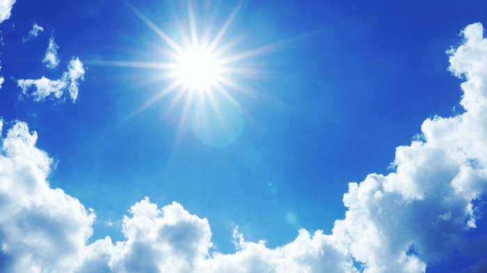 4K bright sun and clouds in blue sky
