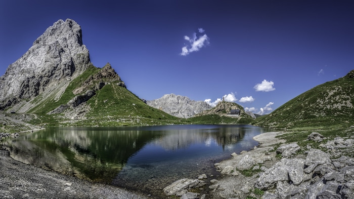 Mountain lake with reflection and building