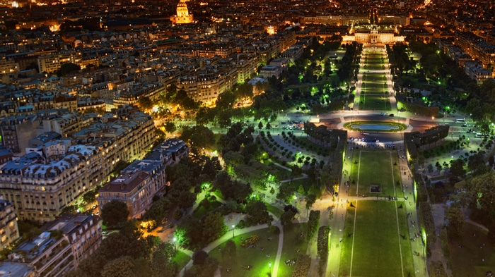 4K Paris cityscape at night with gardens and buildings