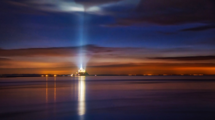 4K Mont Saint-Michel at night with light beam