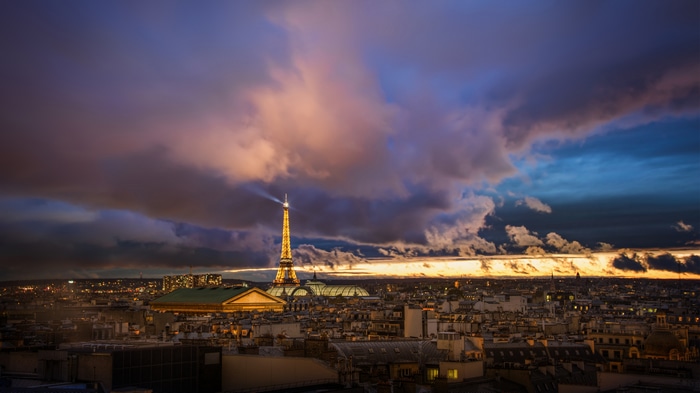 Eiffel Tower at sunset with dramatic clouds