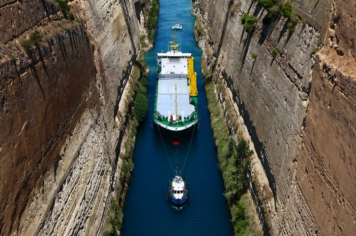 Ship and tugboat in Corinth Canal