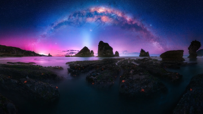Milky Way over rocky coast at night
