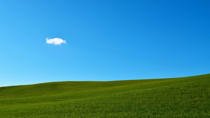 4K landscape of green hills under a blue sky