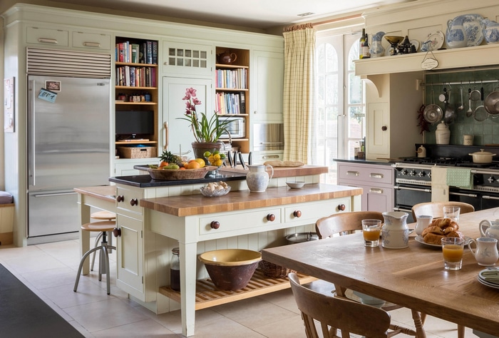 Kitchen with island, fridge, and dining table
