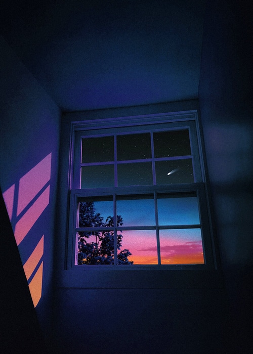 Night sky with stars and a comet seen through a window