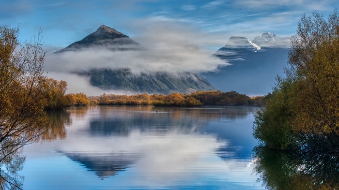 4K reflection of mountains and clouds over water in New Zealand