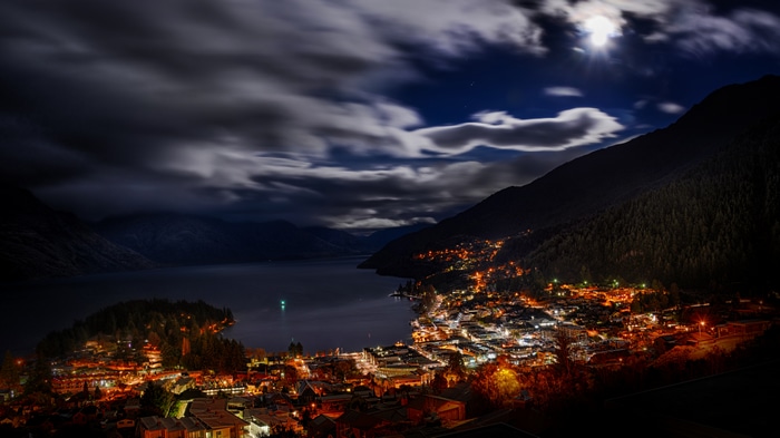 Queenstown New Zealand at Night with Moon and Clouds