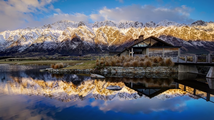 4K snow-capped mountains reflected in water near Queenstown, New Zealand