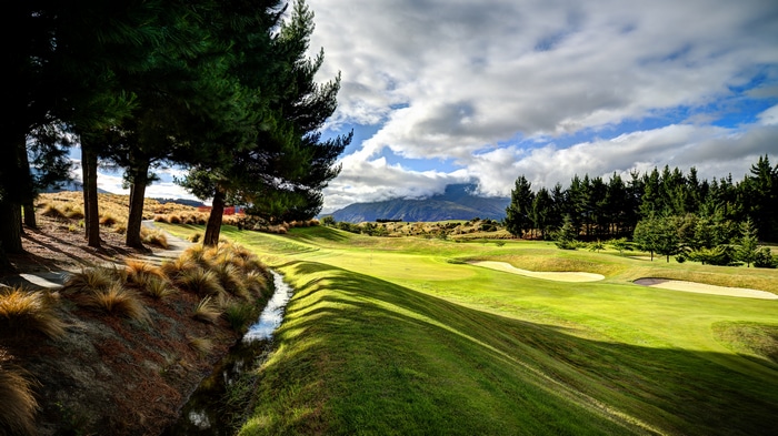 4K New Zealand Golf Course Landscape with Trees and Mountains