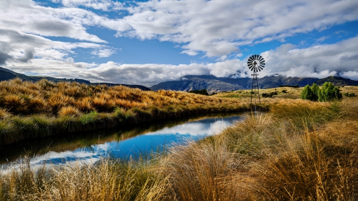 4K New Zealand Landscape with Windmill and Water