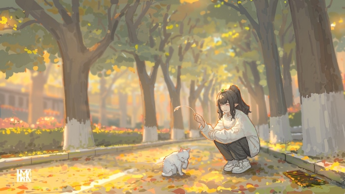Girl playing with a cat on a street with fallen leaves