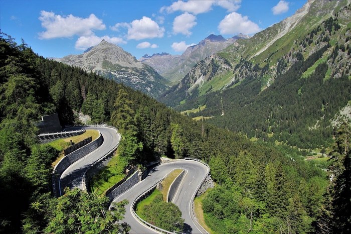 Winding mountain road through a forest valley