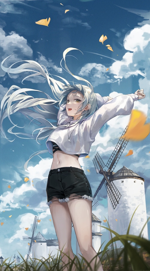 Girl with arms up in front of windmills