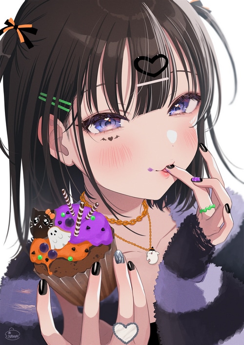 Girl with Halloween cupcake and painted nails