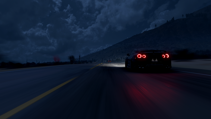 Nissan GT-R driving on a road at night in Forza Horizon 5