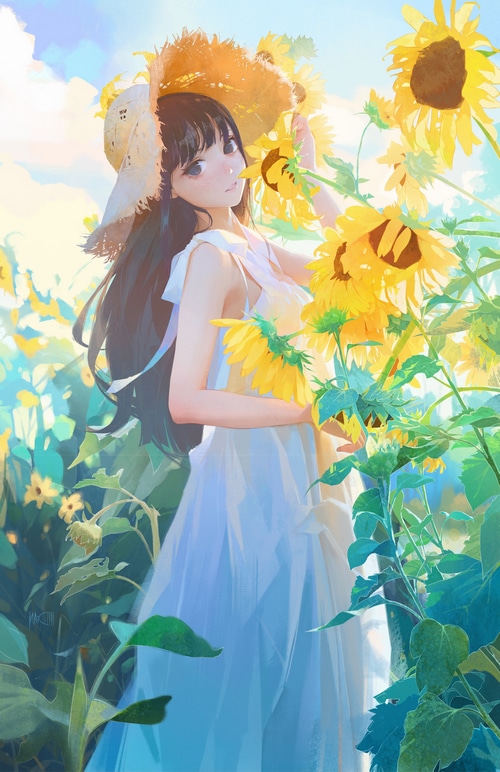 Girl in a straw hat in a sunflower field