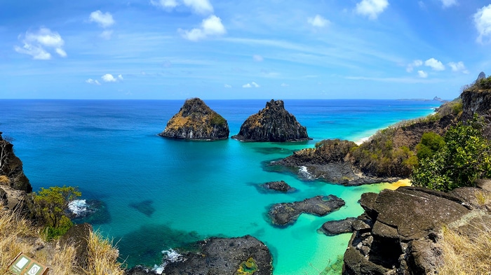 Two rocky islands in the turquoise waters of Fernando de Noronha, Brazil
