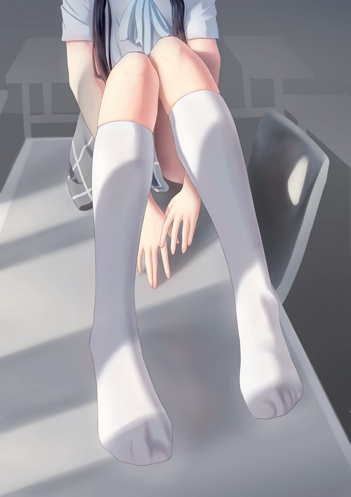 Girl in white socks and skirt sitting indoors