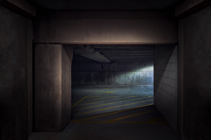 Dark Brutalist Parking Lot with Yellow Markings
