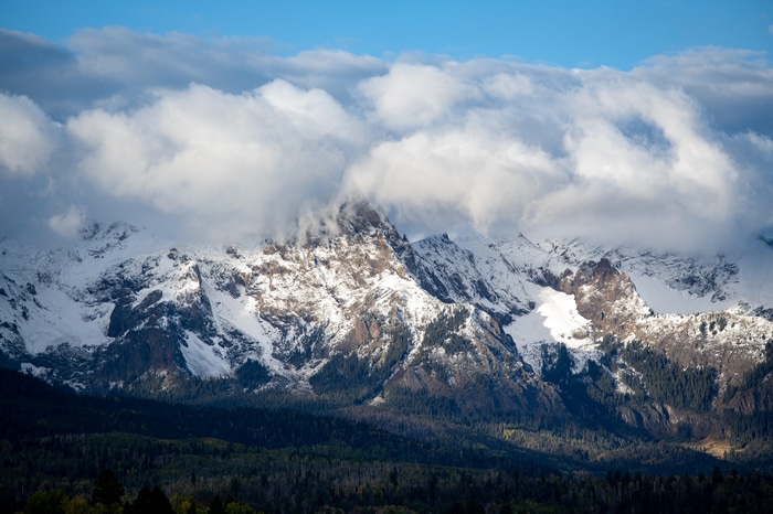 Snow-capped mountains in Colorado with clouds