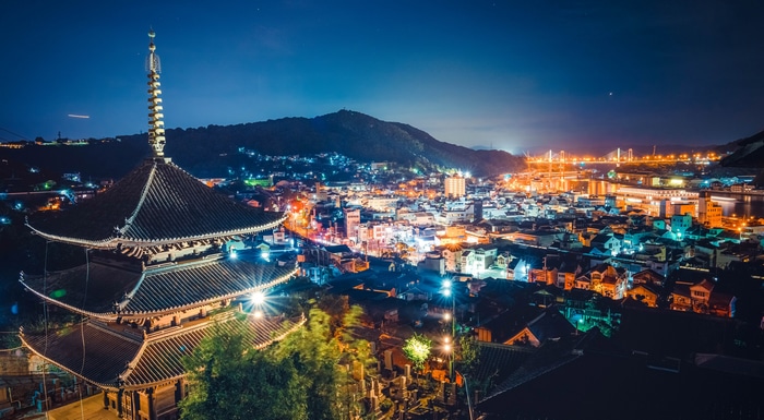 Night view of a Japanese city with a pagoda