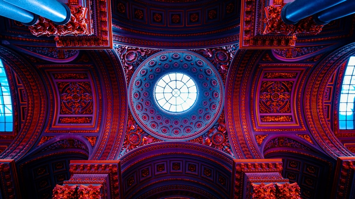 Interior of Château de Versailles with ornate dome and windows