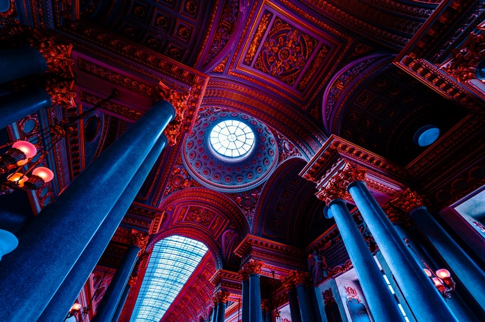 Interior of Château de Versailles with ornate ceiling and columns