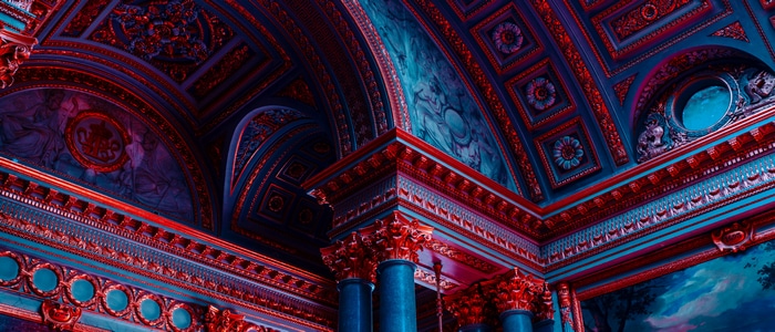 Château de Versailles interior with ornate ceiling and columns
