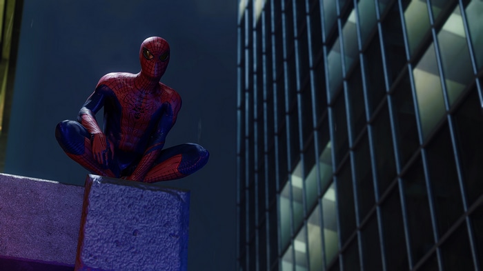 Spider-Man crouches on a ledge at night