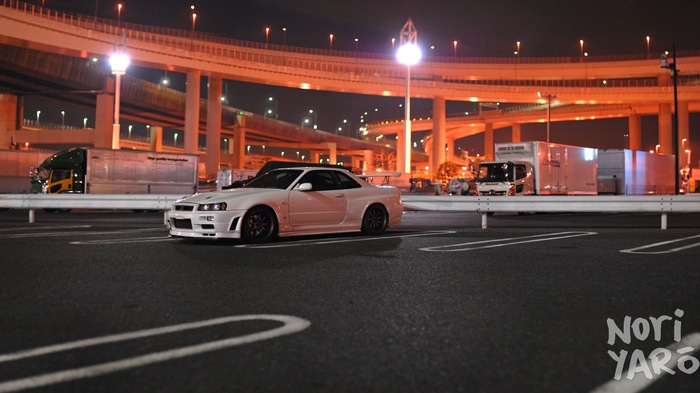 White Nissan Skyline R34 in Daikoku Parking Area at Night