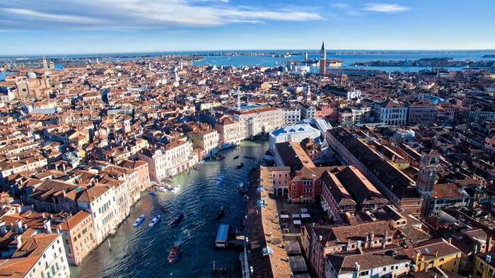 4K Aerial View of Venice Canal with Boats and Buildings