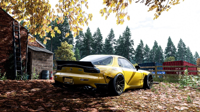 Yellow Mazda RX-7 in a forest setting