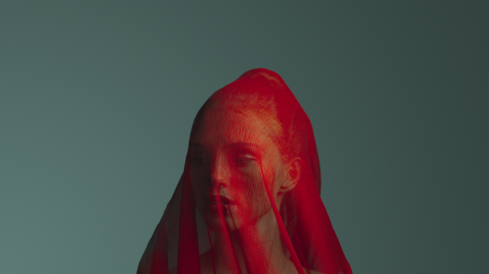 Woman covered in red fabric