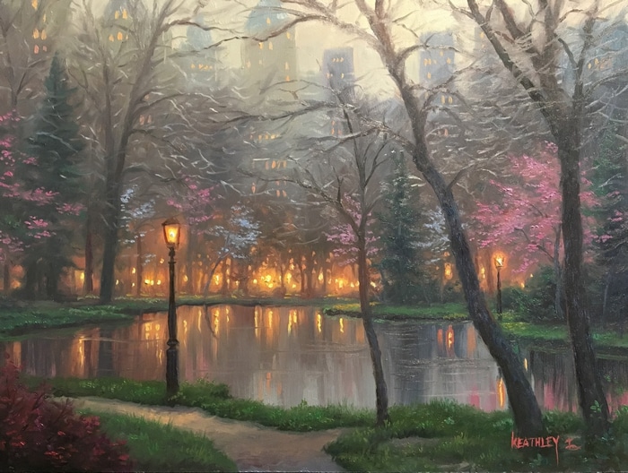 Park lake with streetlights and city buildings at dusk