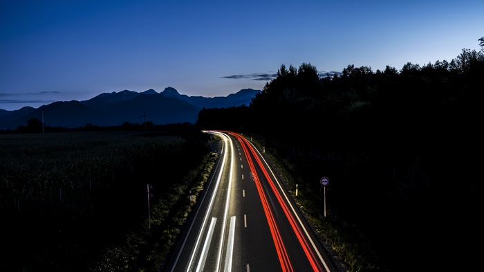 Long exposure of a highway at night with mountains