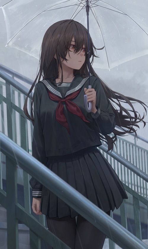 Schoolgirl with umbrella in the rain