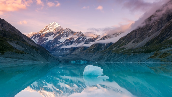 4K icebergs on a lake with snow-capped mountains