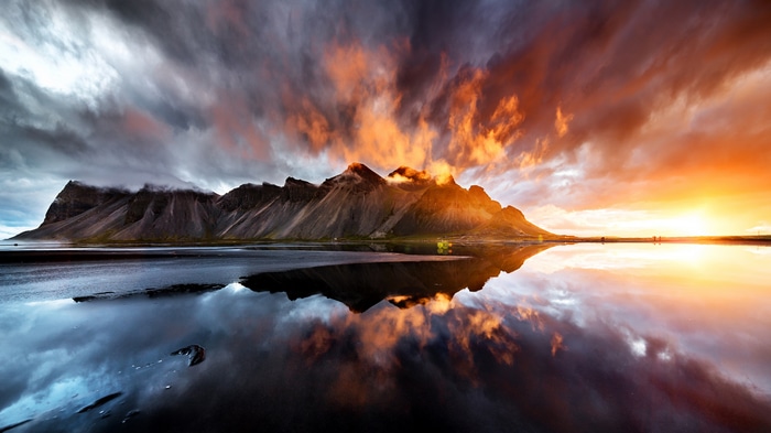 4K sunset over mountains with reflection