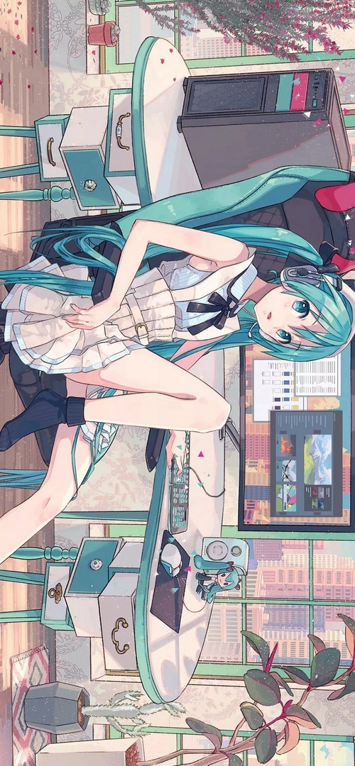 Hatsune Miku sitting at a computer desk