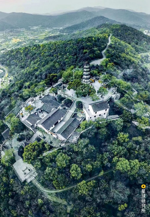 Pagoda and traditional buildings on a forested mountain