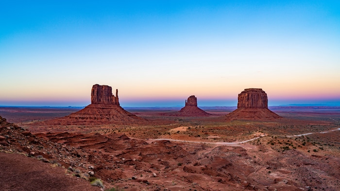 Monument Valley at sunrise with mesas and desert landscape