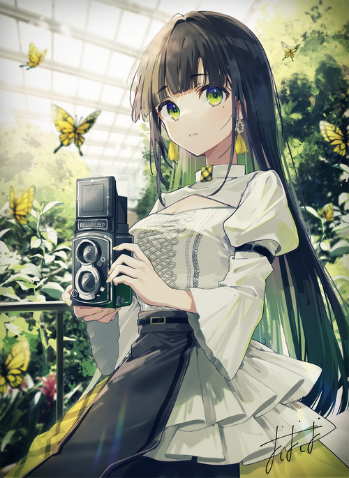 Girl with green eyes holding a camera surrounded by butterflies