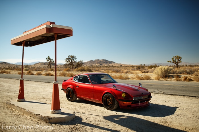 Red Nissan S30 at a desert gas station