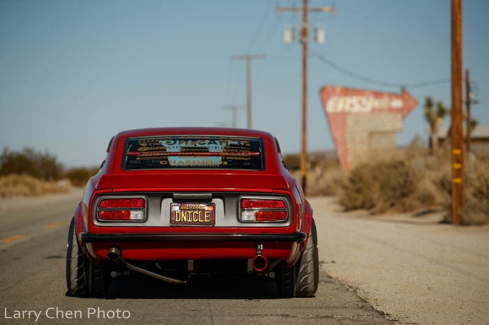 Red Nissan S30 sports car in desert landscape
